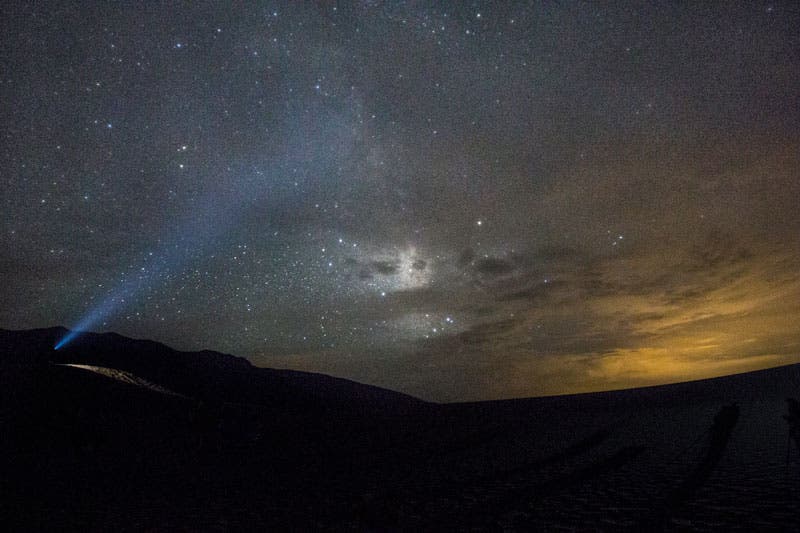 NightSkies06_LinseyDodaro_800 A photo workshop participant's headlamp lights up the starry skies over Great Sand Dunes National Park