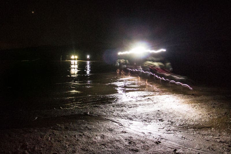 Photo workshop participants' headlamps show the way as they re-cross Medano Creek in Great Sand Dunes National Park