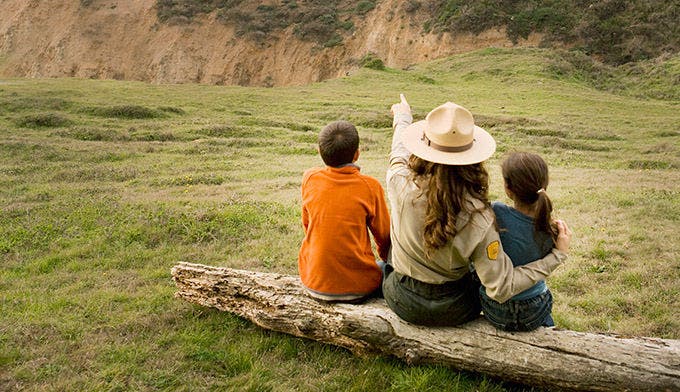 Park Ranger sitting with Children in a national park