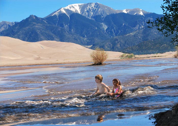 Children playing in Medano Creek at Great Sand Dunes National Park