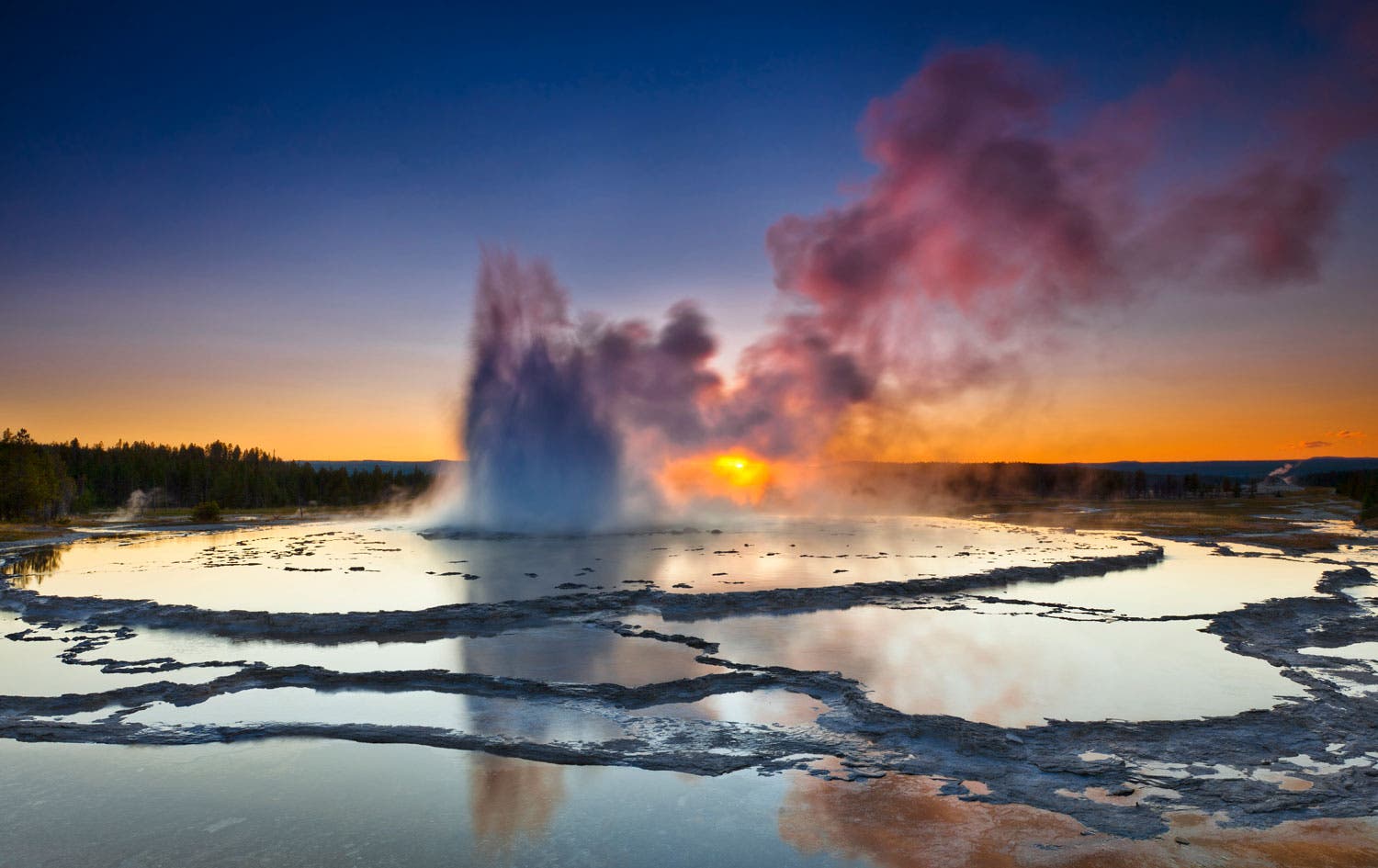 Yellowstone's Great Fountain Geyser at sunset.