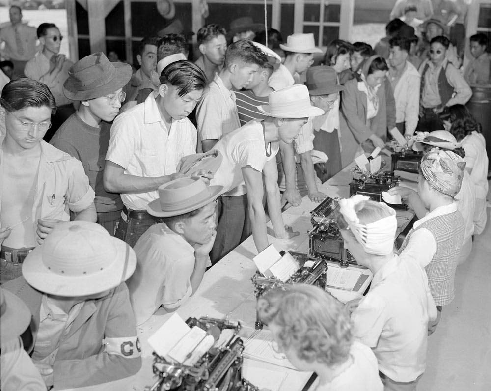 First arrivals at this relocation center are registering for internment at Amache