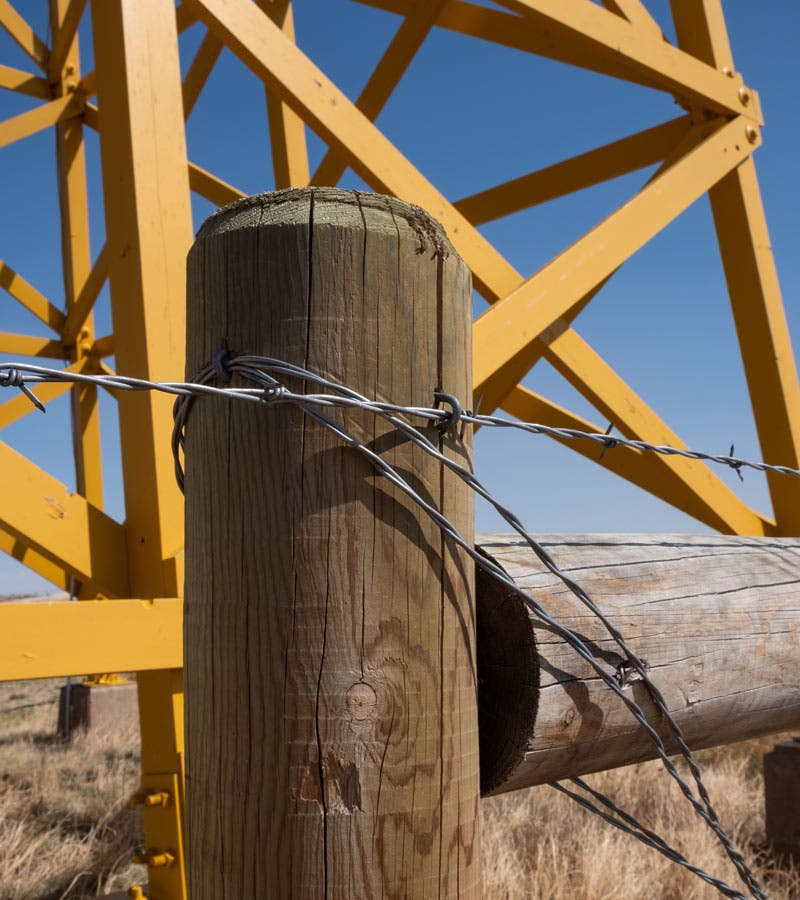 Barbed wire fence by the water tower at Amache