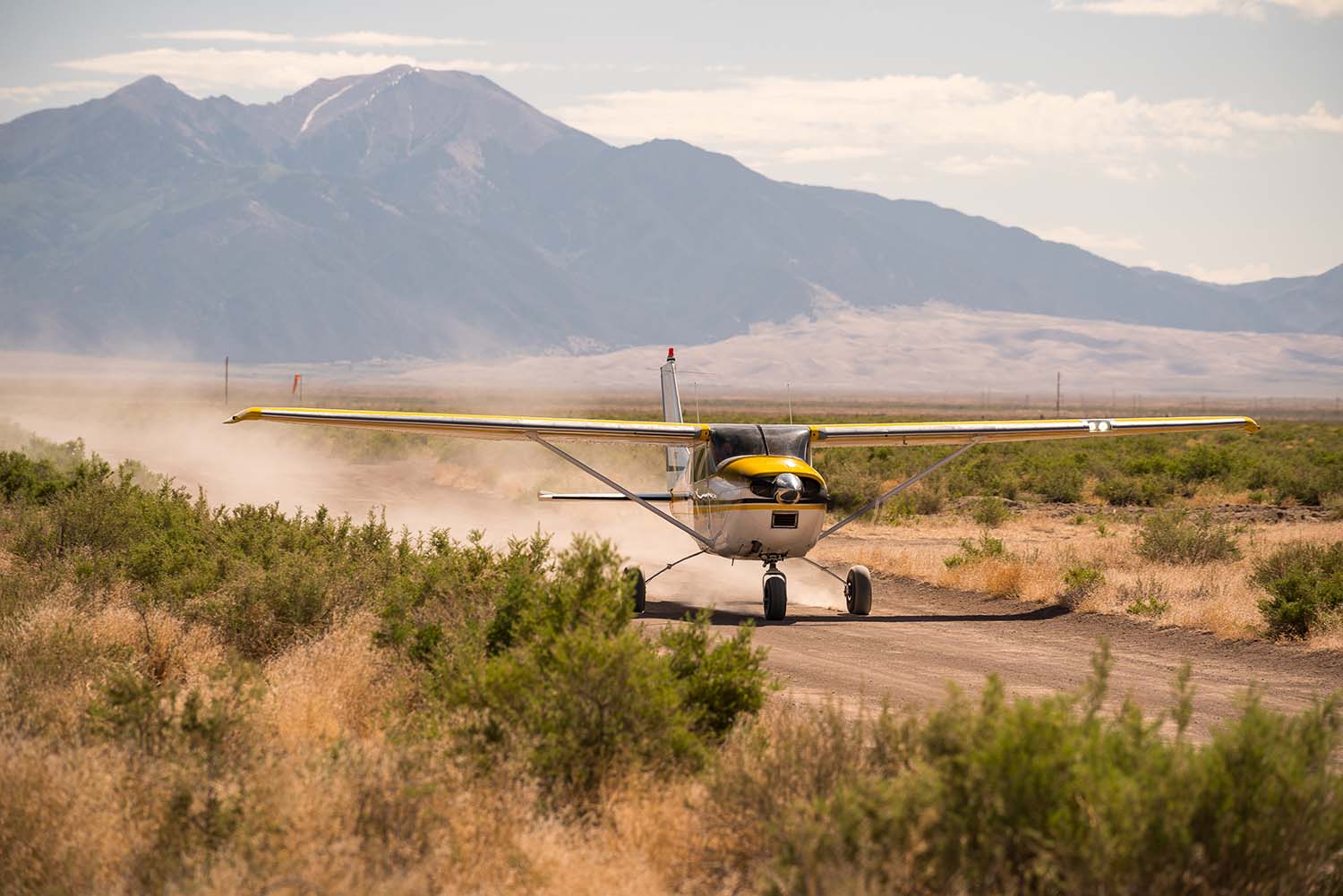 A plane taking off for incredible views of the Sangre de Cristo mountains