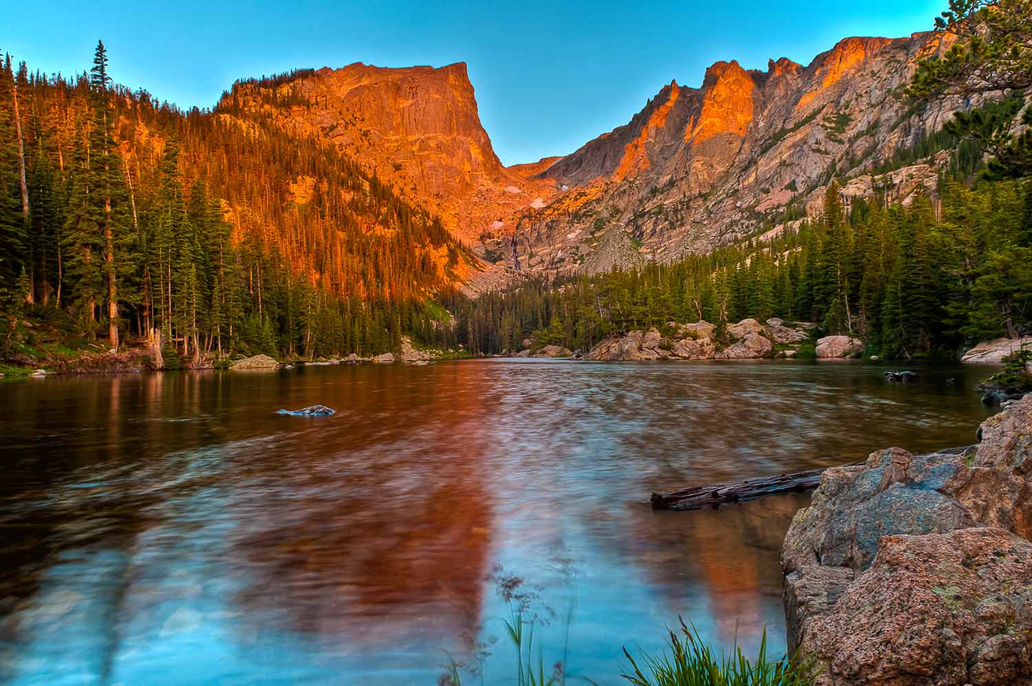 Dream Lake glows during golden hour in Rocky Mountain National Park
