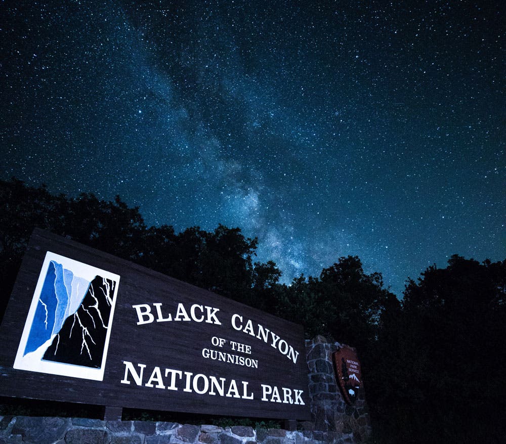 The Milky Way over the entrance sign at Black Canyon of the Gunnison National Park in Colorado